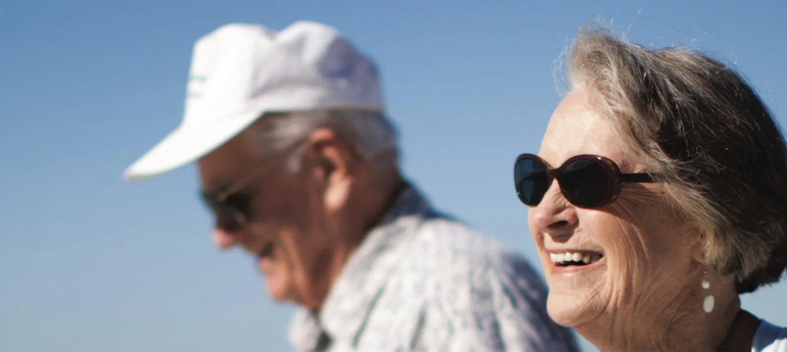 Two people walking on a sunny day