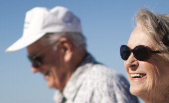 Two people walking on a sunny day