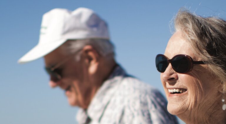 Two people walking on a sunny day