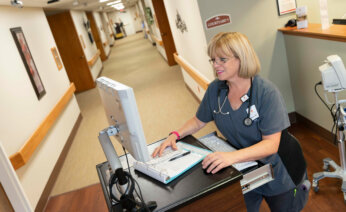 Nurse enter information into a computer