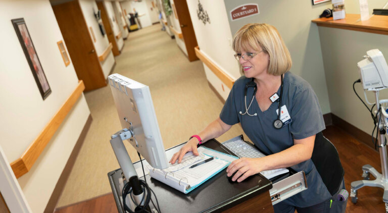 Nurse enter information into a computer