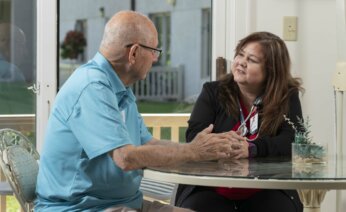 Nurse and resident talking