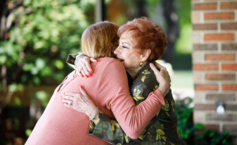 Two people embrace in a hug