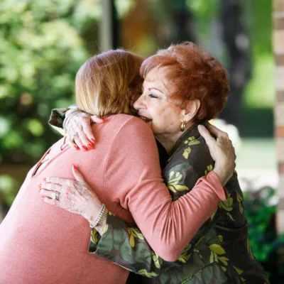 Two people embrace in a hug