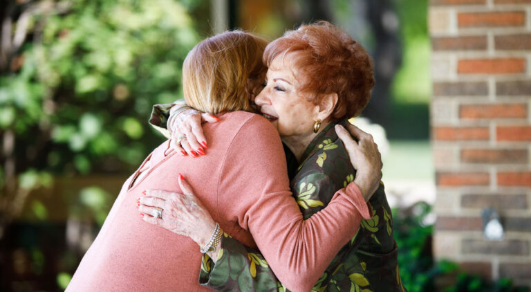 Two people embrace in a hug