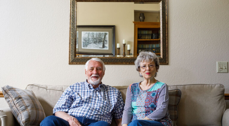 Independent living couple sitting on their couch