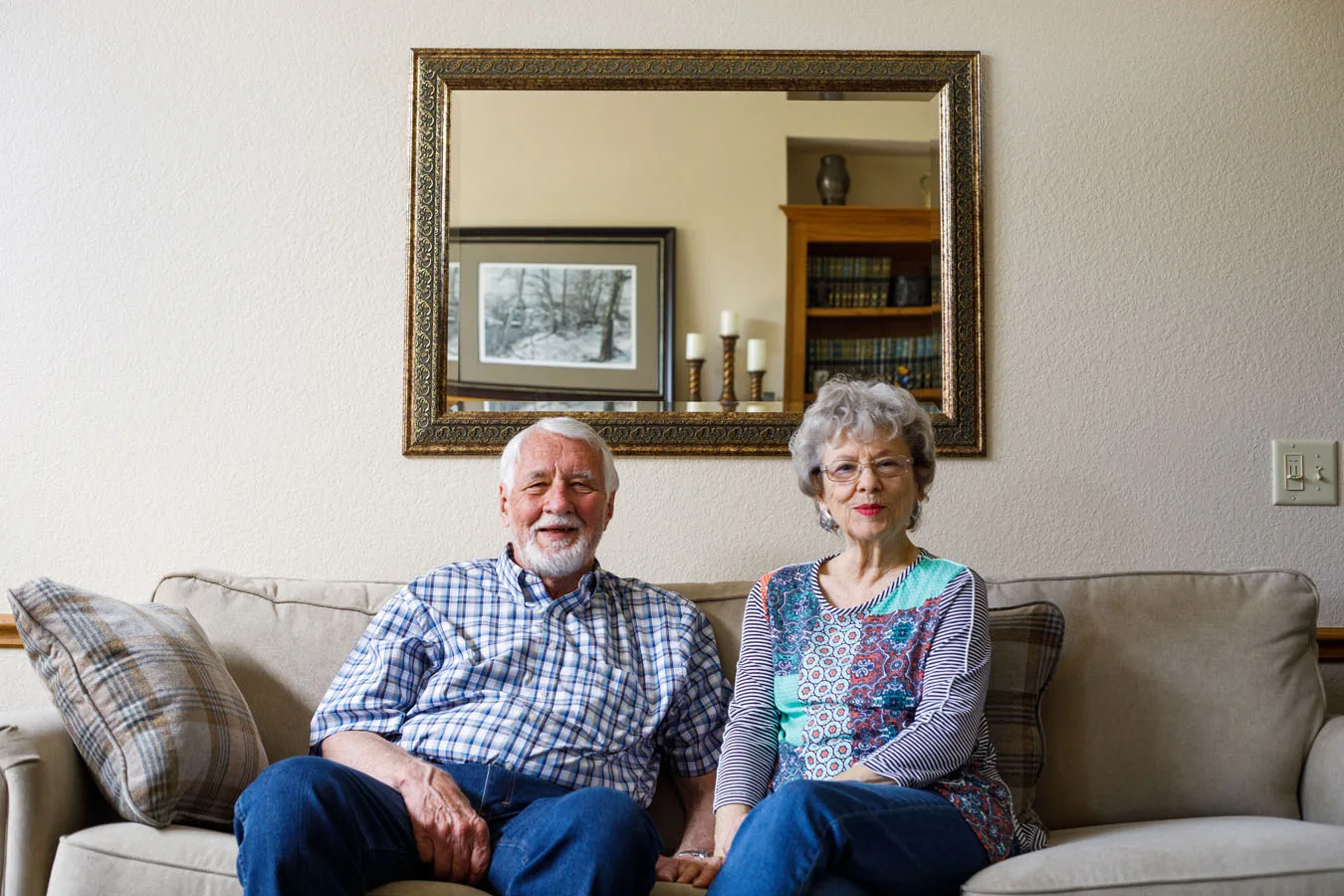 Independent living couple sitting on their couch