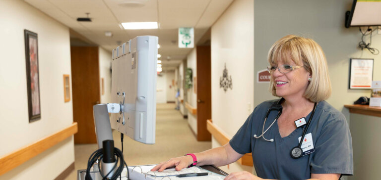 Nurse putting information into the computer