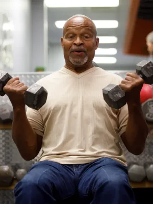 Man in gym lifting weights