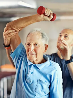 Fitness - man lifting weights with trainer