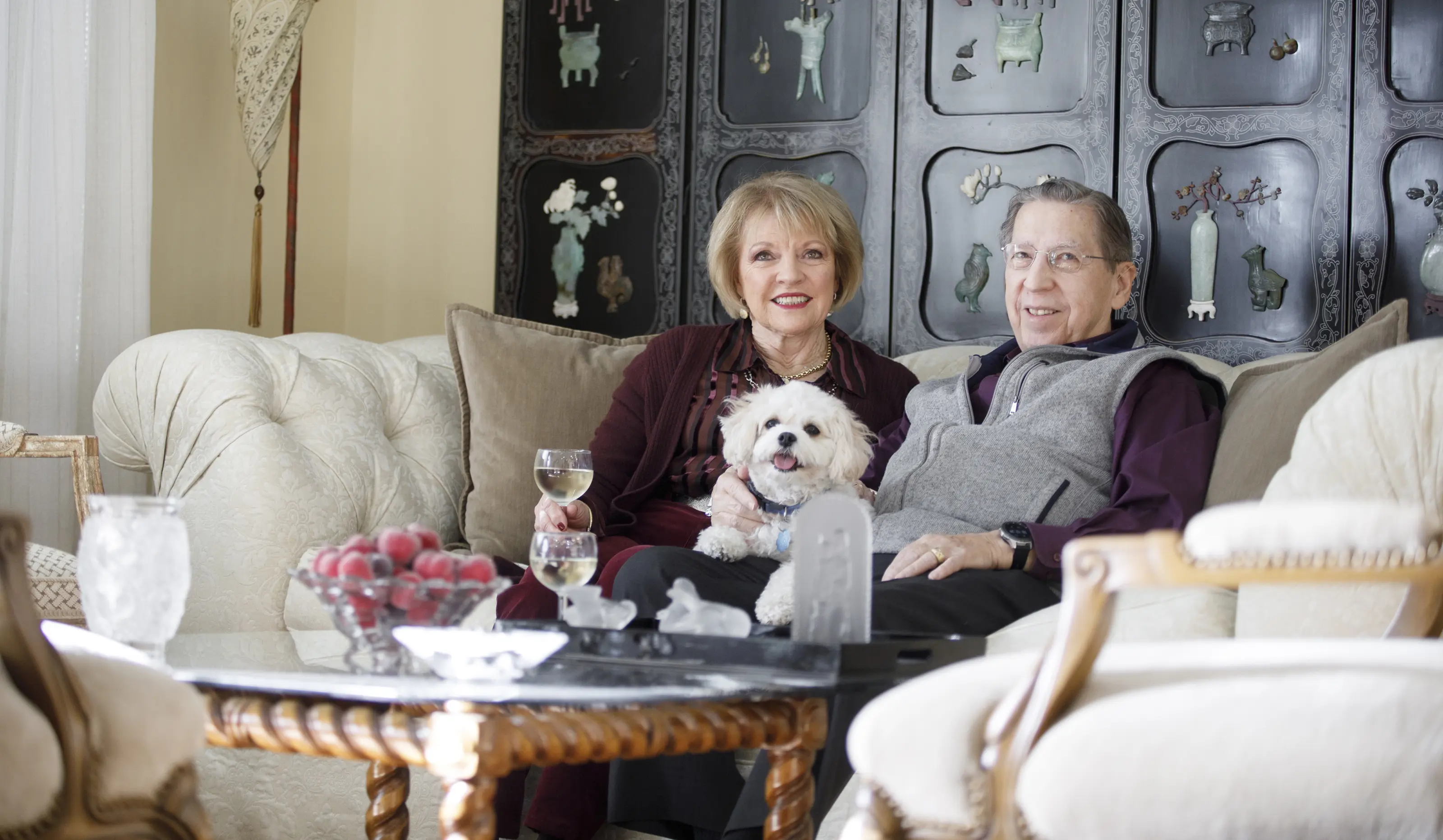 Happy couple on couch with their dog