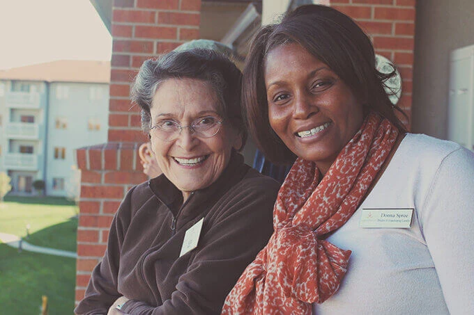 Two women posing for photograph